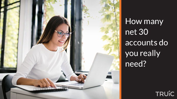 Woman with a notebook looking for net 30 accounts.