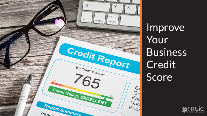 A credit report on a desk next to a laptop