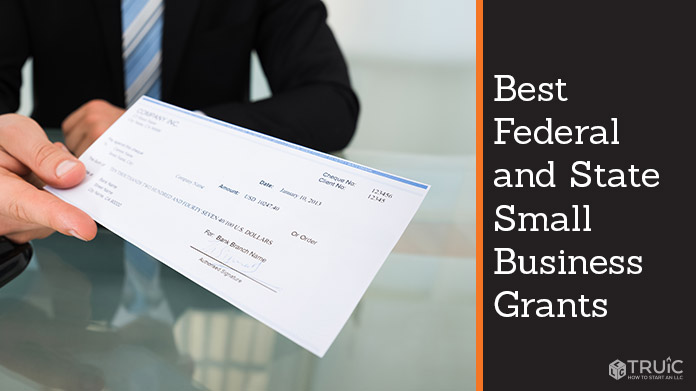Businessman holding check.