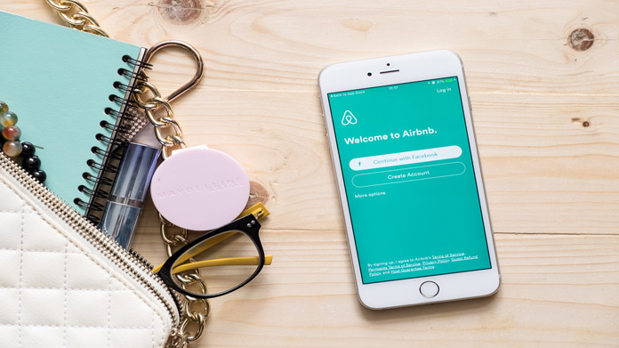 A cellphone with the Airbnb app on the screen