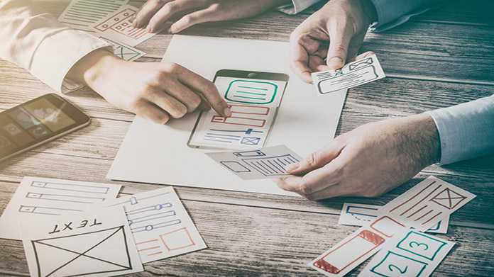 People using papers to develop an app design