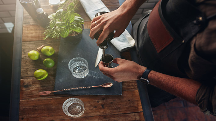 A bartender pouring a drink