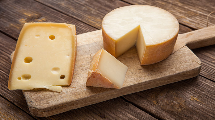 A variety of cheeses on a cheese board
