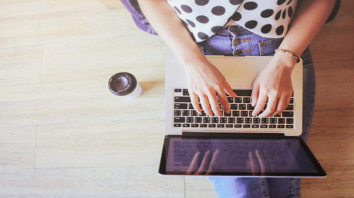 A person typing on a laptop
