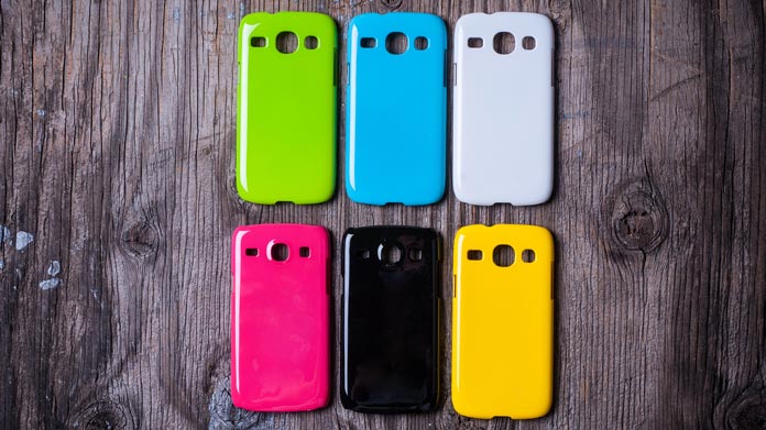 6 colored custom phone cases display on a desk