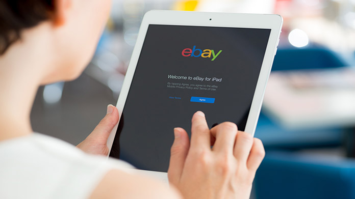 A person logging into ebay on a tablet