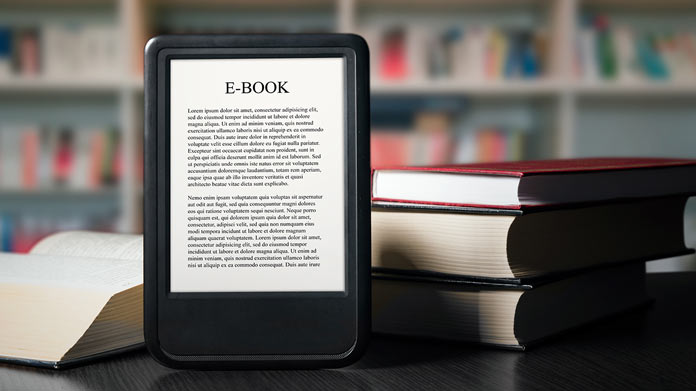 An e-book propped up by a pile of books