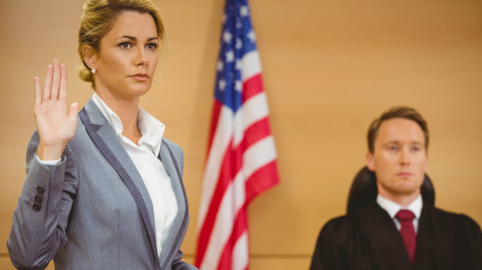A woman being sworn in to court