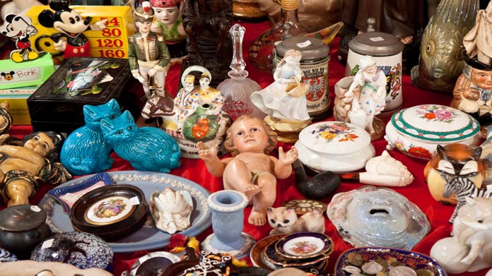 table with a bunch of antiques and items at a flea market