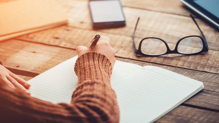 A person writing in a journal