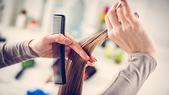 Hands styling and cutting hair