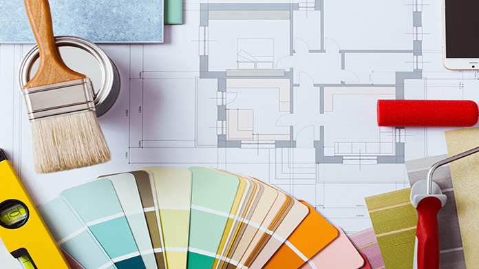 Paint swatches sitting on top of a house floor plan