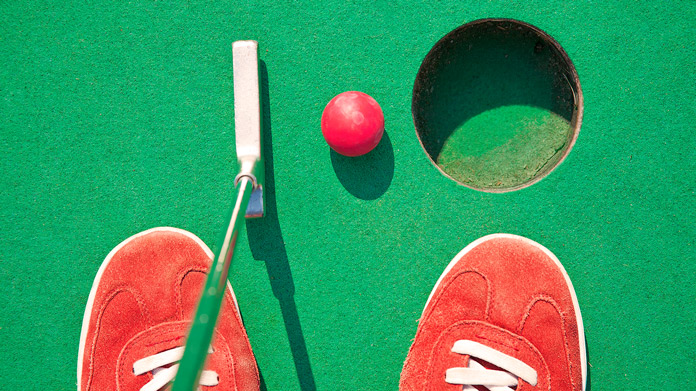 Person playing miniature golf