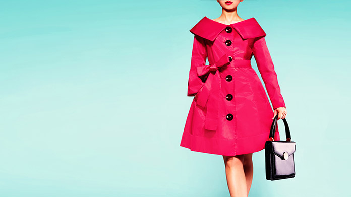 a model showing off her designer outfit and designer purse