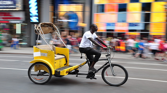 Man driving a pedal-driven vehicle