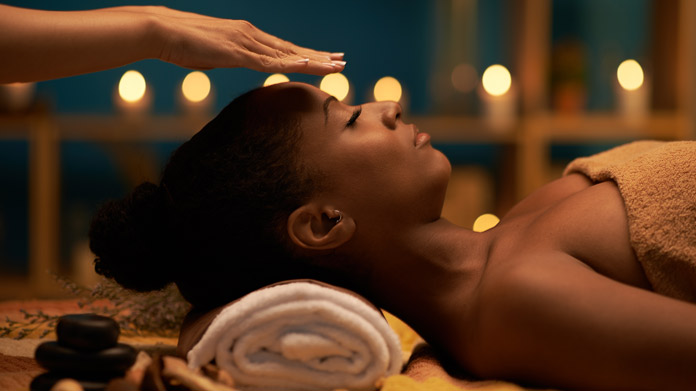A person participating in a reiki session
