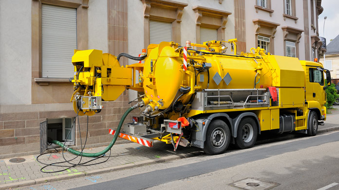 Septic truck cleaning a septic tank