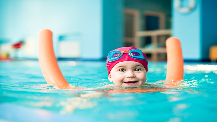 A little toddler swimming in a pool