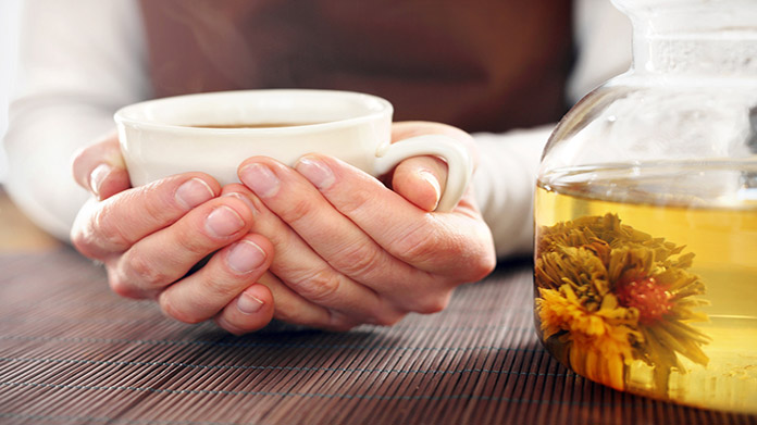 someone holding a cup of tea