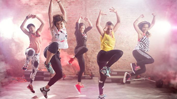 Five people performing Zumba