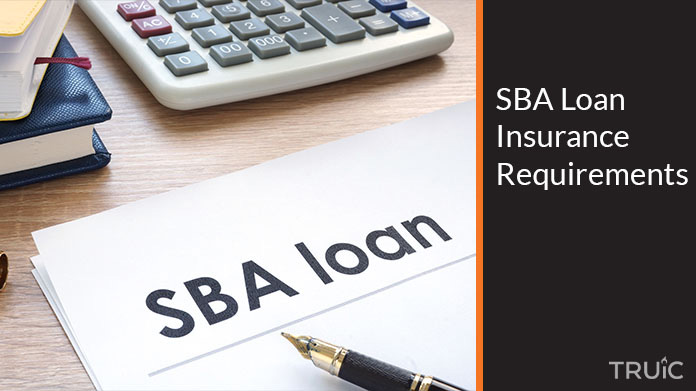 SBA Loan paperwork on a desk with other desk items.