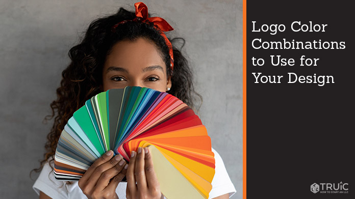 A woman holding a rainbow of color palettes.