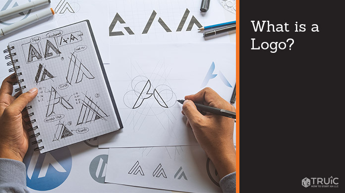 A designer sketching a logo design on a piece of paper.