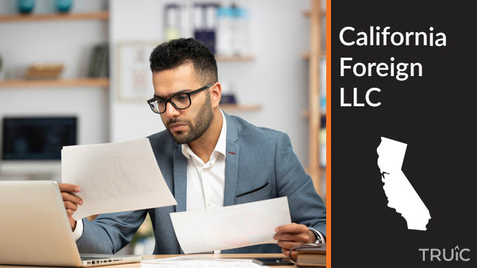 Man looking at paperwork to form his foreign LLC.
