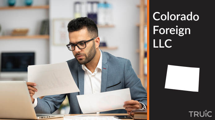 Man looking at paperwork to form his foreign LLC.