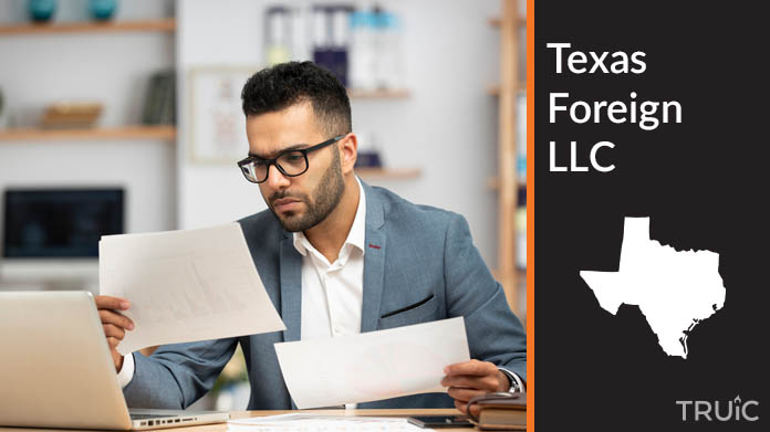 Man looking at paperwork to form his foreign LLC.
