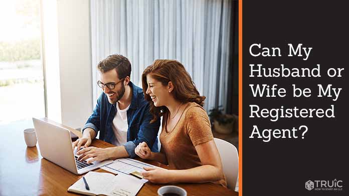 Couple working together at home laptop.